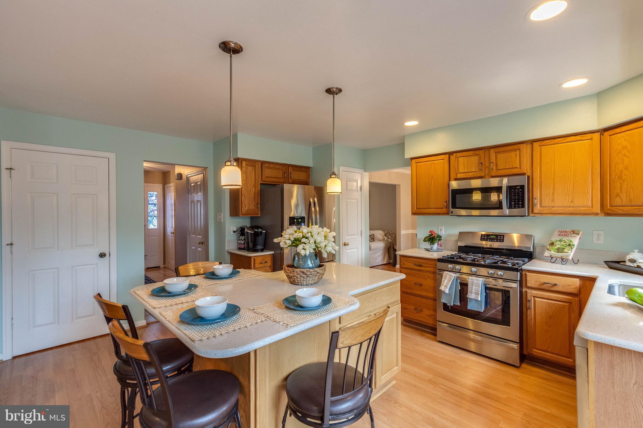 1746 Canal Run Drive Point of Rocks, MD 21777 - Photo 6 of 30 a kitchen with stainless steel appliances a dining table chairs and sink