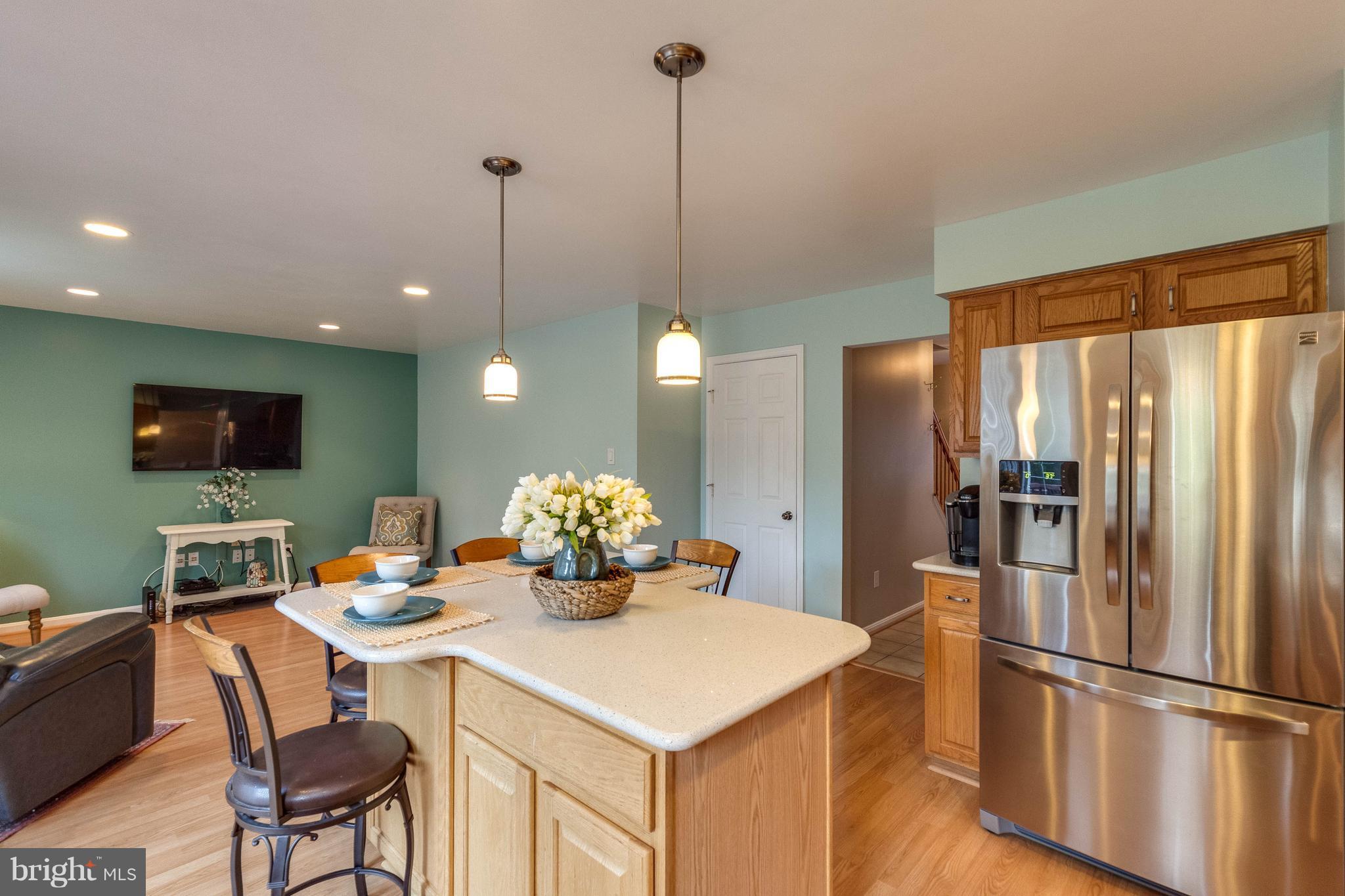 1746 Canal Run Drive Point of Rocks, MD 21777 - Photo 7 of 30 a kitchen with a refrigerator a dining table and chairs