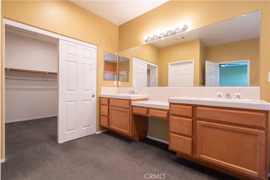 11480 Autumn Glen Court Porter Ranch, CA 91326 - Photo 16 of 38 a spacious bathroom with a double vanity sink a mirror and a bathtub