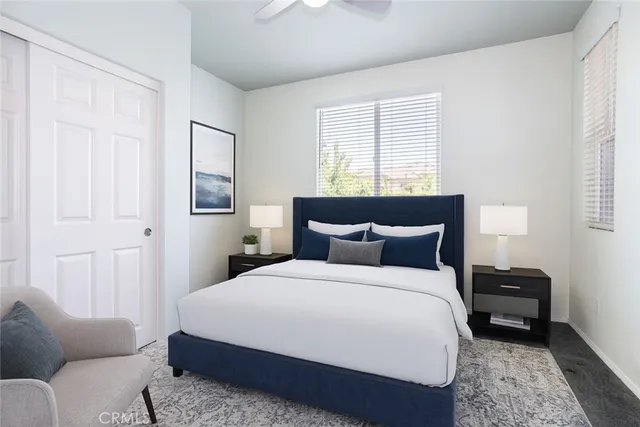 a bedroom with a bed a couch and a window