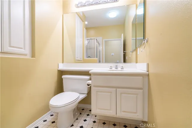 a bathroom with a sink a toilet and mirror