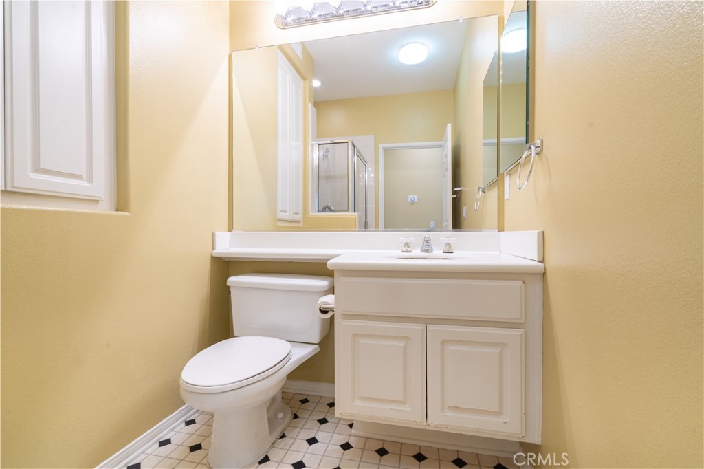 11480 Autumn Glen Court Porter Ranch, CA 91326 - Photo 24 of 38 a bathroom with a sink a toilet and mirror