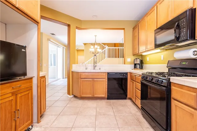 a kitchen with stainless steel appliances a stove a sink and a microwave