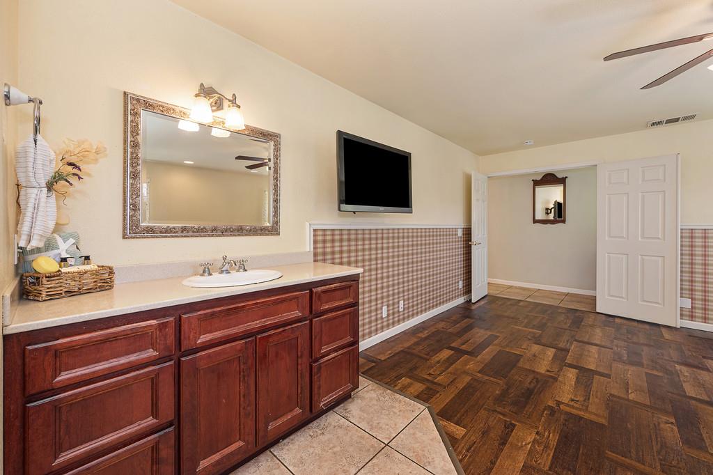 6181 Lambert Lane El Dorado, CA 95623 - Photo 44 of 68 full bath featuring ceiling fan, vanity, and light tile patterned floors