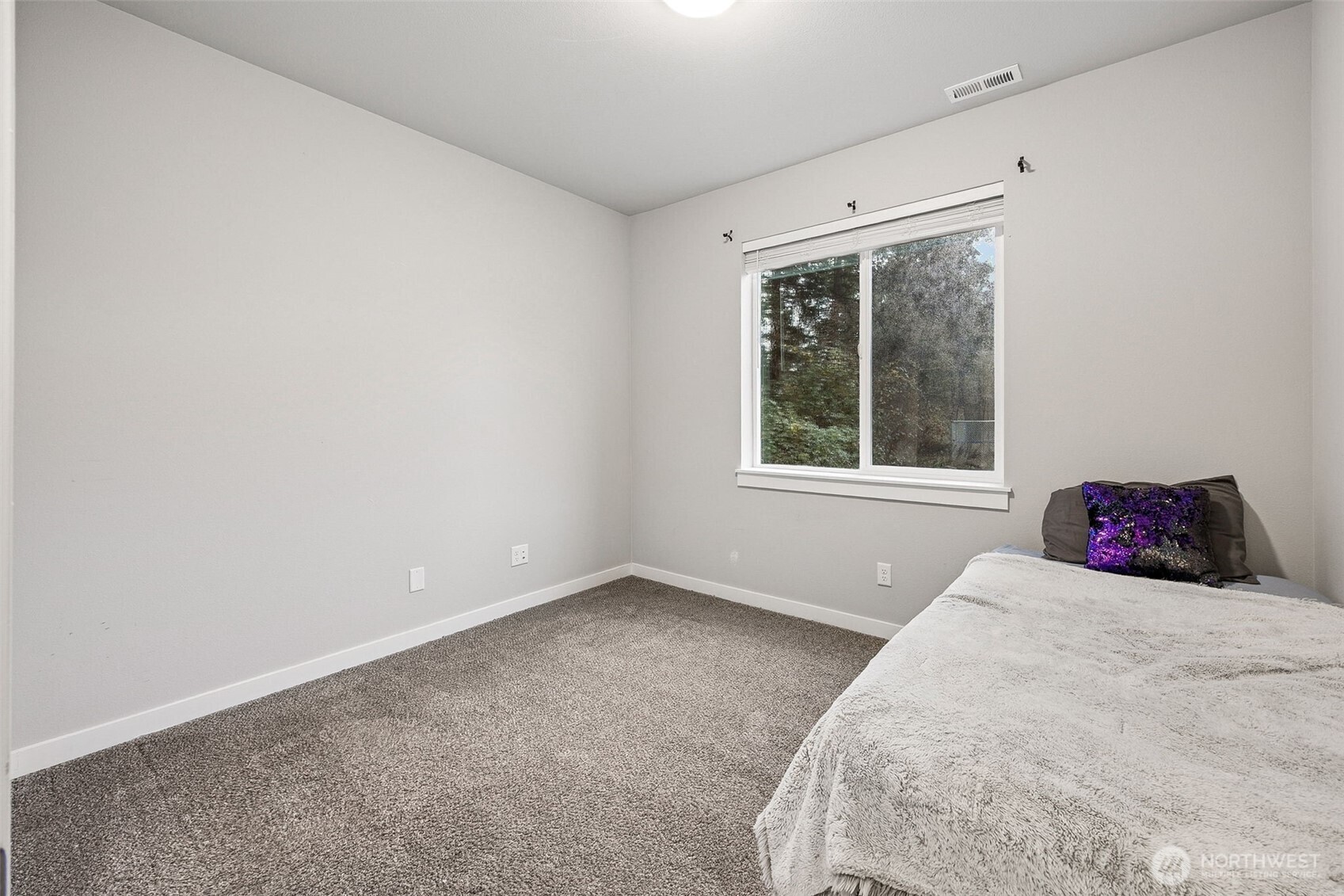 12016 264th Street East Graham, WA 98338 - Photo 16 of 40 a view of a bedroom with a large bed and a window