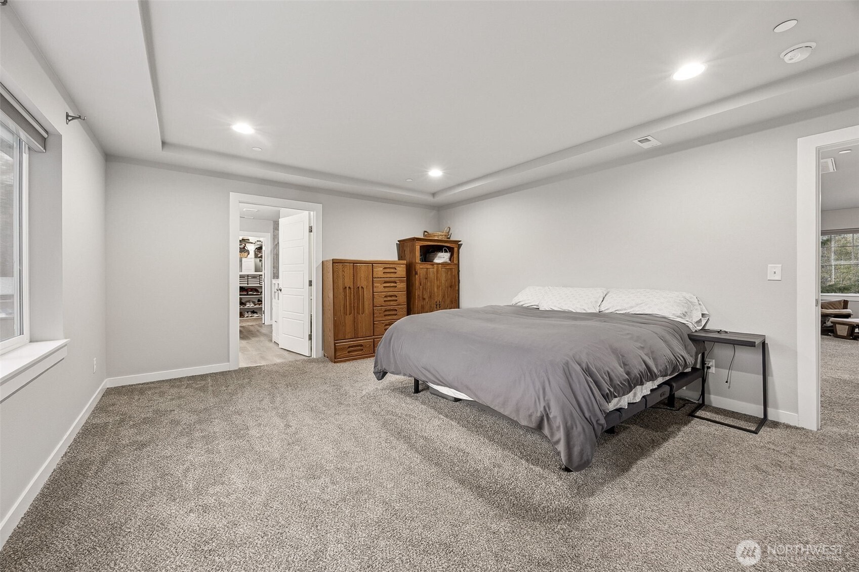 12016 264th Street East Graham, WA 98338 - Photo 19 of 40 a spacious bedroom with a bed and a cabinets