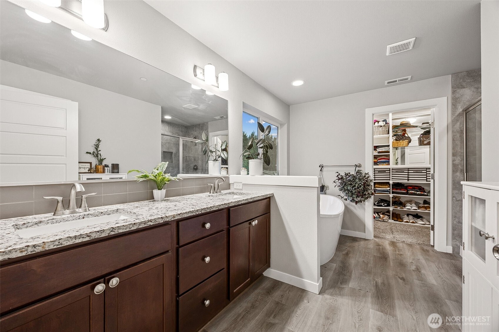 12016 264th Street East Graham, WA 98338 - Photo 20 of 40 a bathroom with a granite countertop sink and a mirror