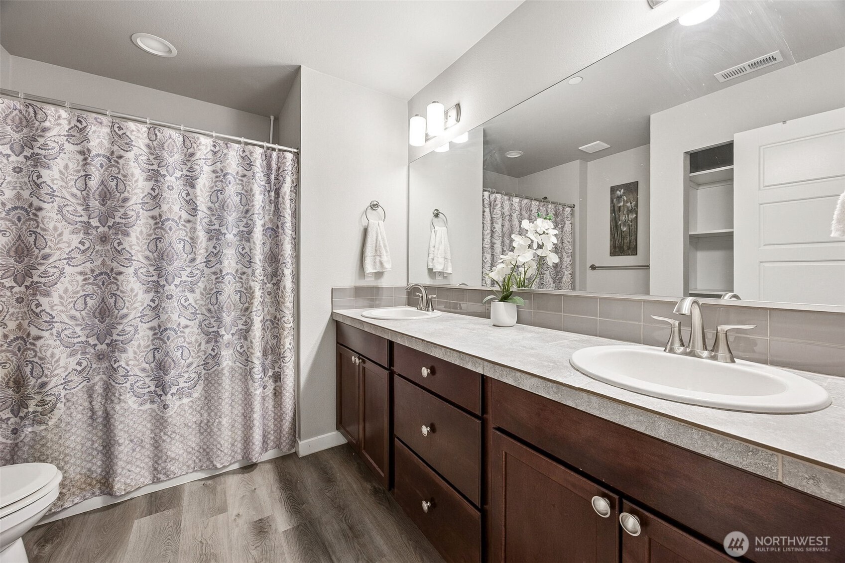 12016 264th Street East Graham, WA 98338 - Photo 23 of 40 a bathroom with a double vanity sink and mirror