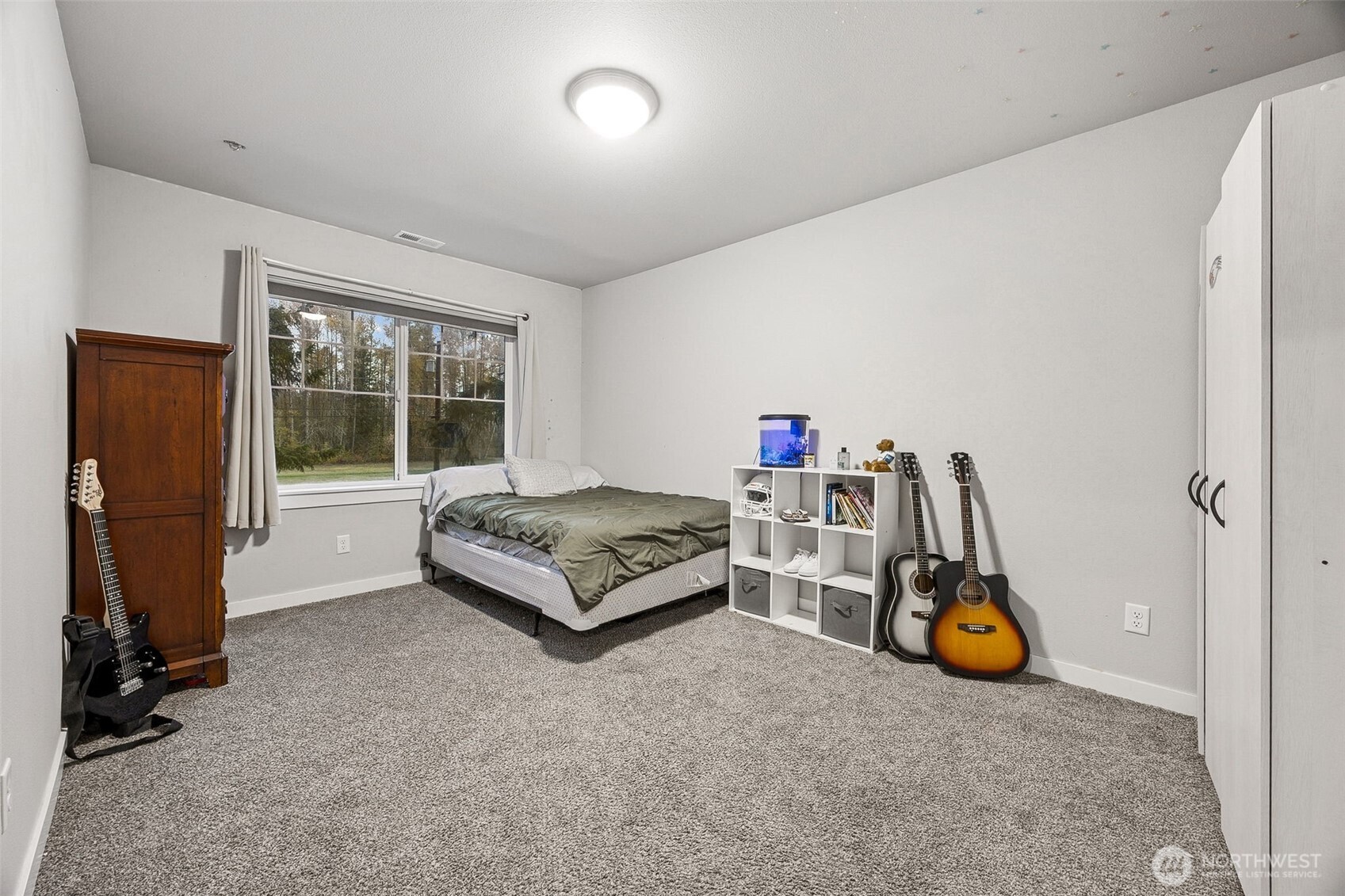 12016 264th Street East Graham, WA 98338 - Photo 29 of 40 a bedroom with furniture and a window