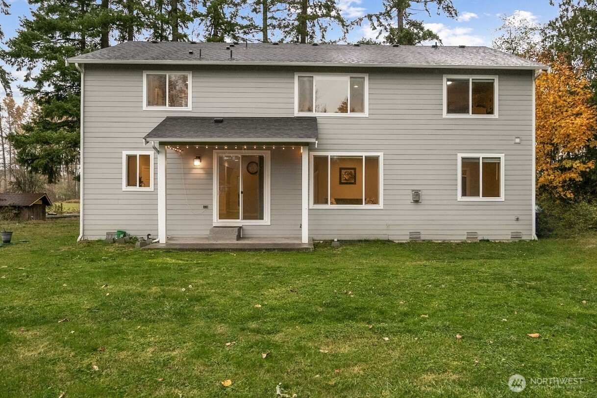 12016 264th Street East Graham, WA 98338 - Photo 31 of 40 a front view of a house with a garden