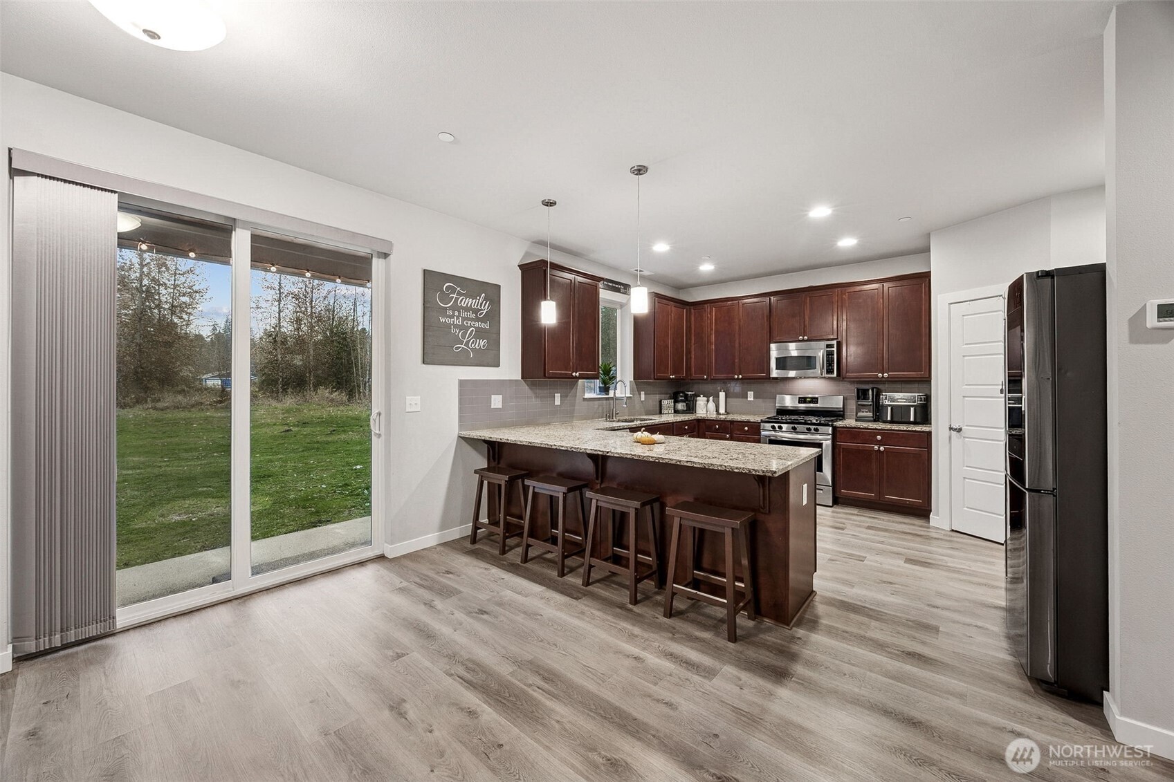 12016 264th Street East Graham, WA 98338 - Photo 8 of 40 a kitchen with stainless steel appliances granite countertop a refrigerator and a stove top oven