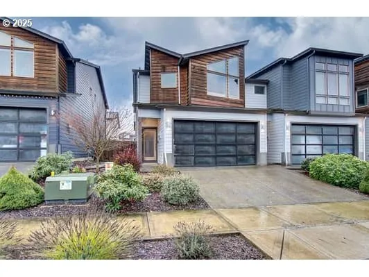 a front view of a house with a yard and a garage