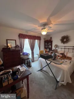a living room with furniture a rug and a large window