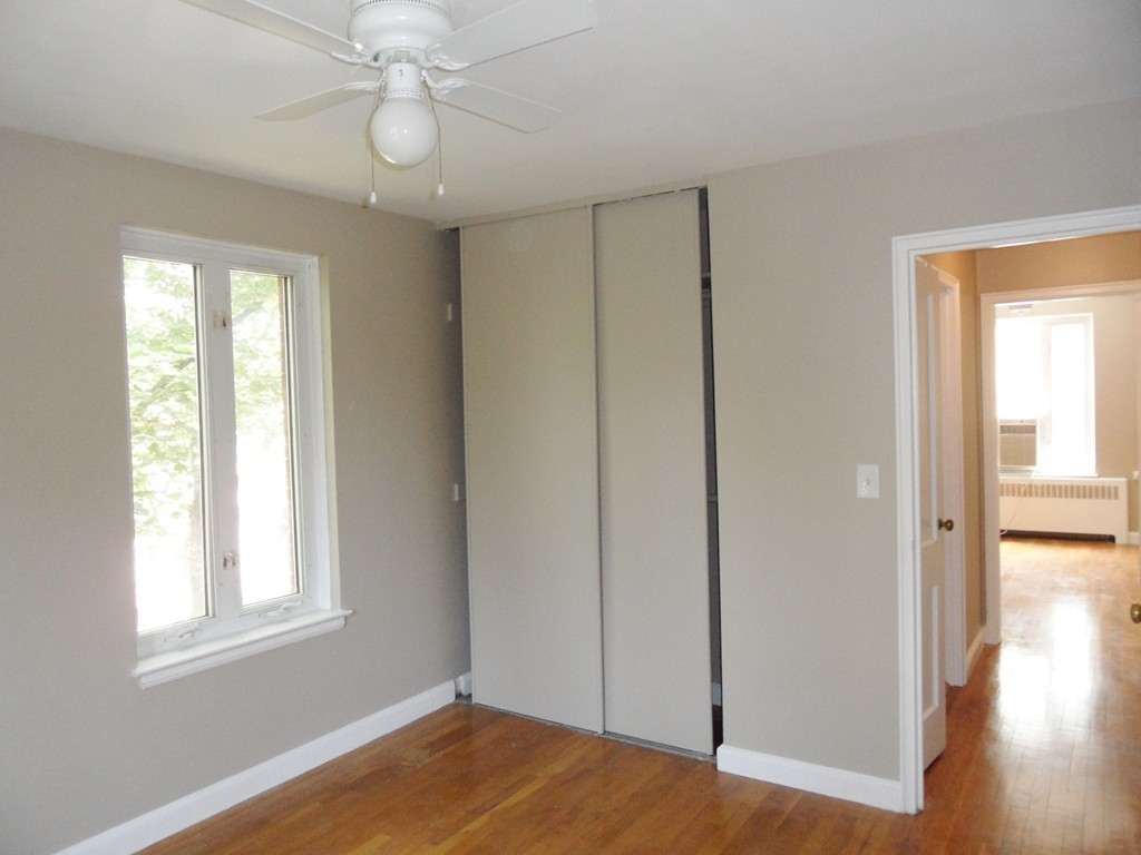 128 Beaconsfield Road, Unit 5 Brookline, MA 02445 - Photo 11 of 18 a view of empty room with wooden floor and fan