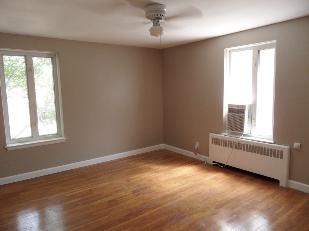 128 Beaconsfield Road, Unit 5 Brookline, MA 02445 - Photo 16 of 18 an empty room with a window