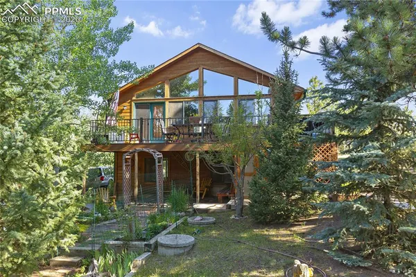 a front view of a house with yard and green space