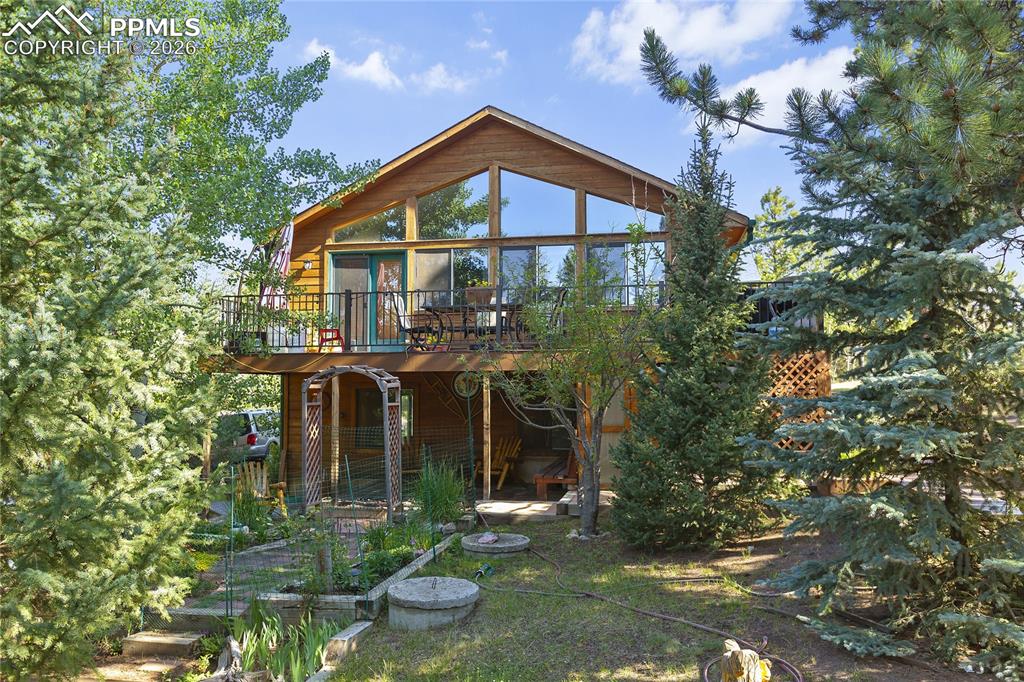 566 Spring Valley Drive Divide, CO 80814 - Photo 1 of 30 a front view of a house with yard and green space