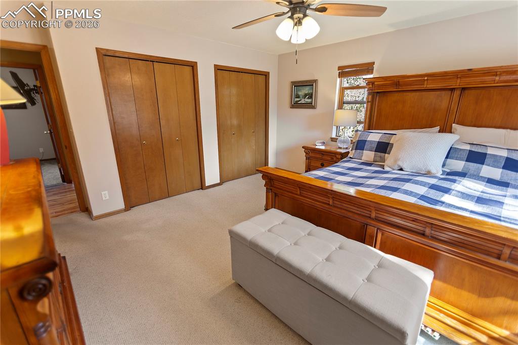 566 Spring Valley Drive Divide, CO 80814 - Photo 11 of 30 a bedroom with a bed and a chandelier