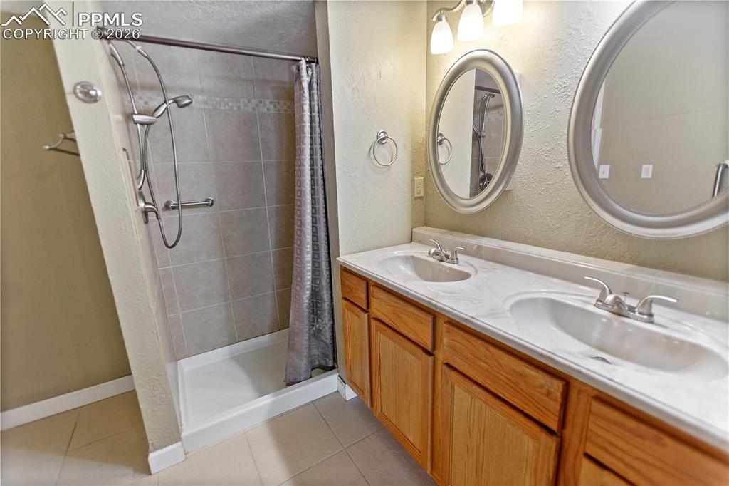 566 Spring Valley Drive Divide, CO 80814 - Photo 22 of 30 a bathroom with a double vanity sink and a mirror