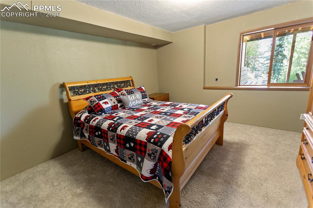 566 Spring Valley Drive Divide, CO 80814 - Photo 23 of 30 a bed sitting in a bedroom next to a window