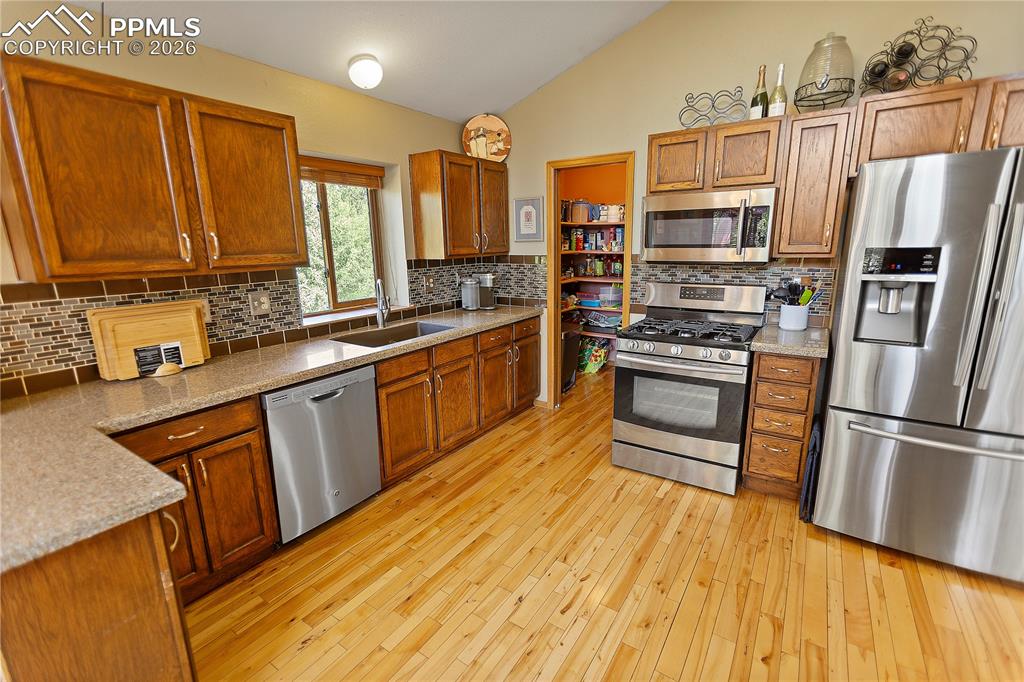 566 Spring Valley Drive Divide, CO 80814 - Photo 7 of 30 a kitchen with stainless steel appliances granite countertop a refrigerator a stove and a sink