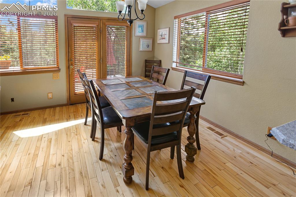 566 Spring Valley Drive Divide, CO 80814 - Photo 9 of 30 a dining room with furniture and wooden floor