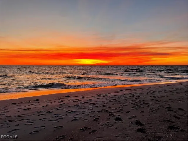 a kitchen with stainless steel appliances granite countertop a refrigerator a sink a stove and black cabinets