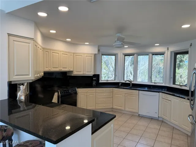 a bedroom with a bed and a lamp on the dresser