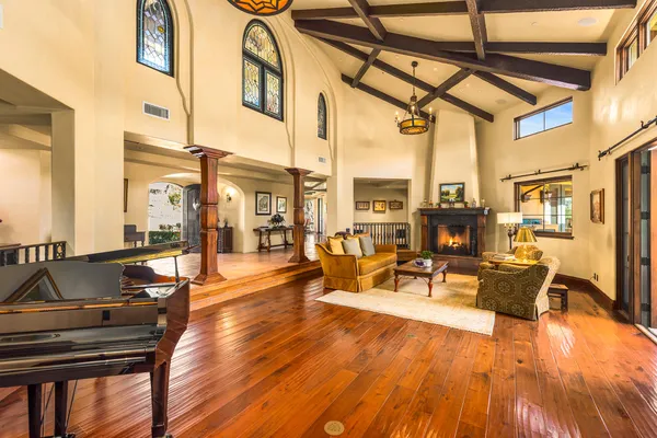 a living room with furniture a fireplace and wooden floor