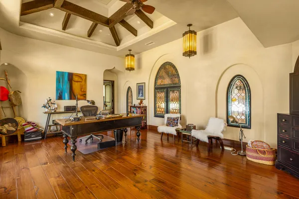a living room with fireplace furniture and a wooden floor