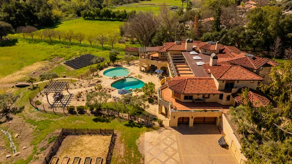 an aerial view of residential houses with outdoor space