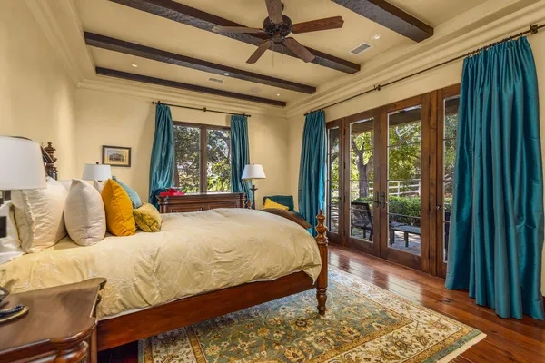 a bedroom with a large bed and a large window