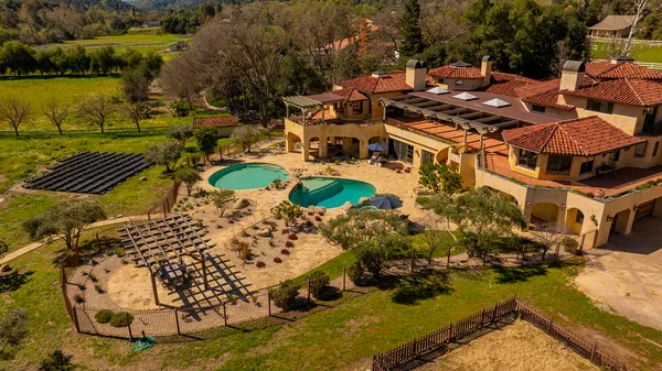 an aerial view of a house with a ocean view