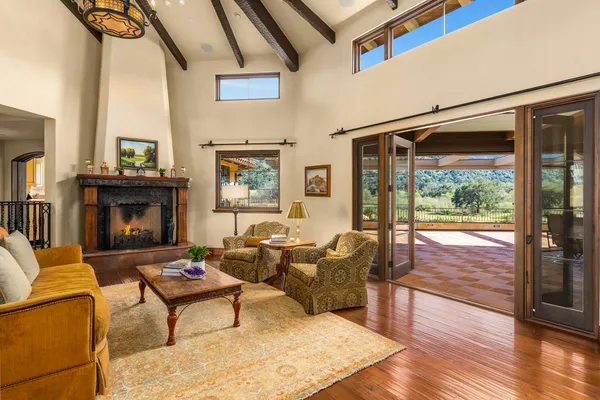 a living room with furniture large window and a fireplace