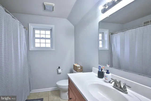 a bathroom with a sink toilet and a mirror