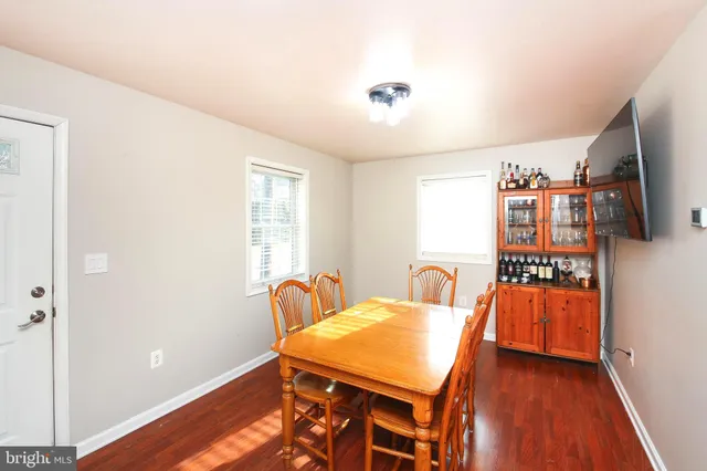 a dining room with furniture and wooden floor