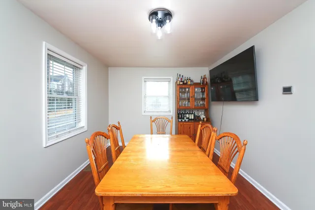 a dining room with furniture a window and wooden floor