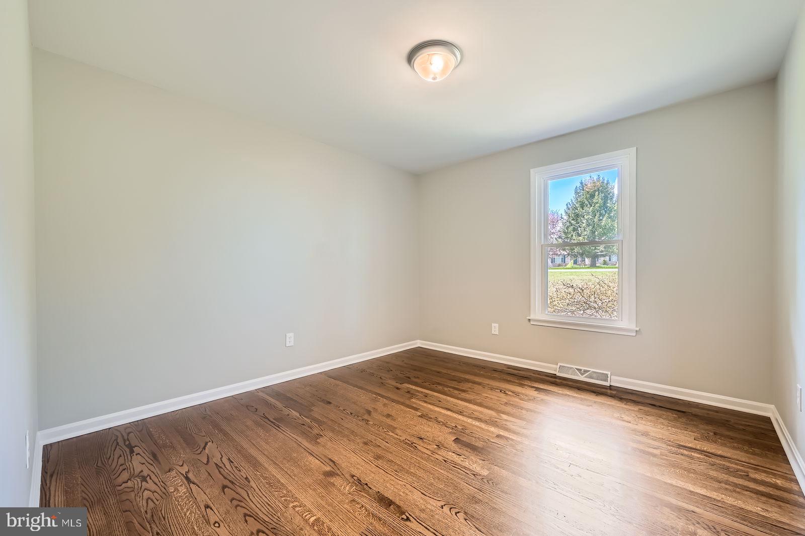2701 Beckleysville Road Manchester, MD 21102 - Photo 20 of 39 an empty room with wooden floor and windows