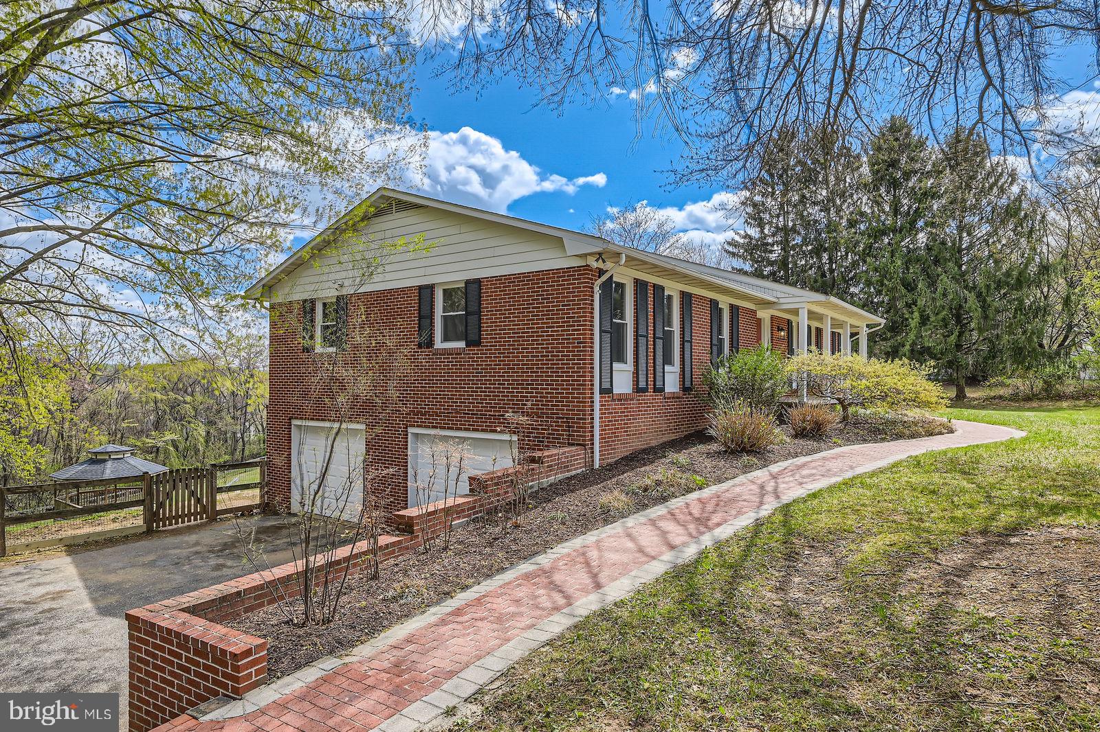 2701 Beckleysville Road Manchester, MD 21102 - Photo 2 of 39 a backyard of a house with large trees and wooden fence