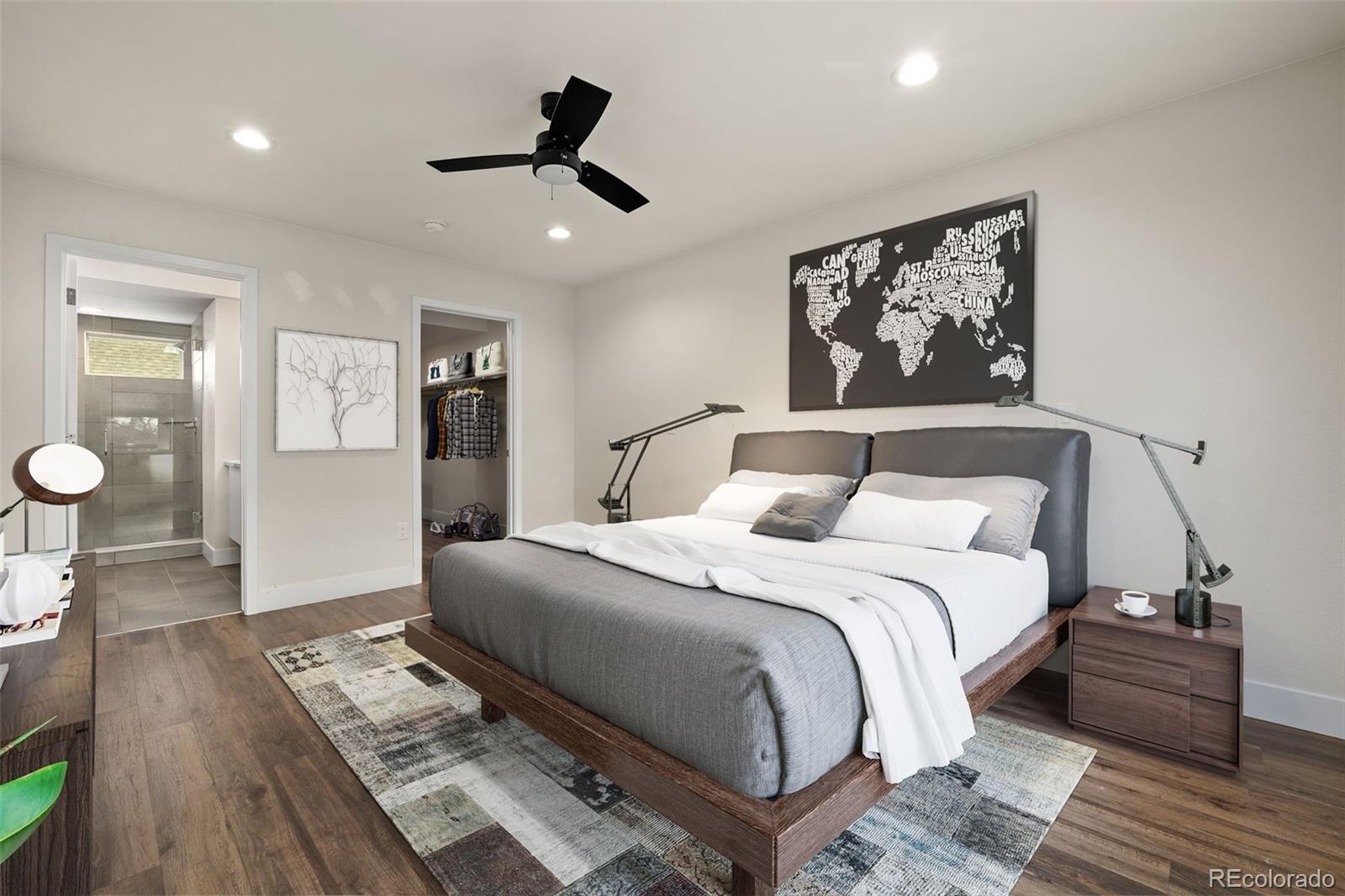 1204 South Reed Street Lakewood, CO 80232 - Photo 12 of 45 a bedroom with a large bed and a chandelier