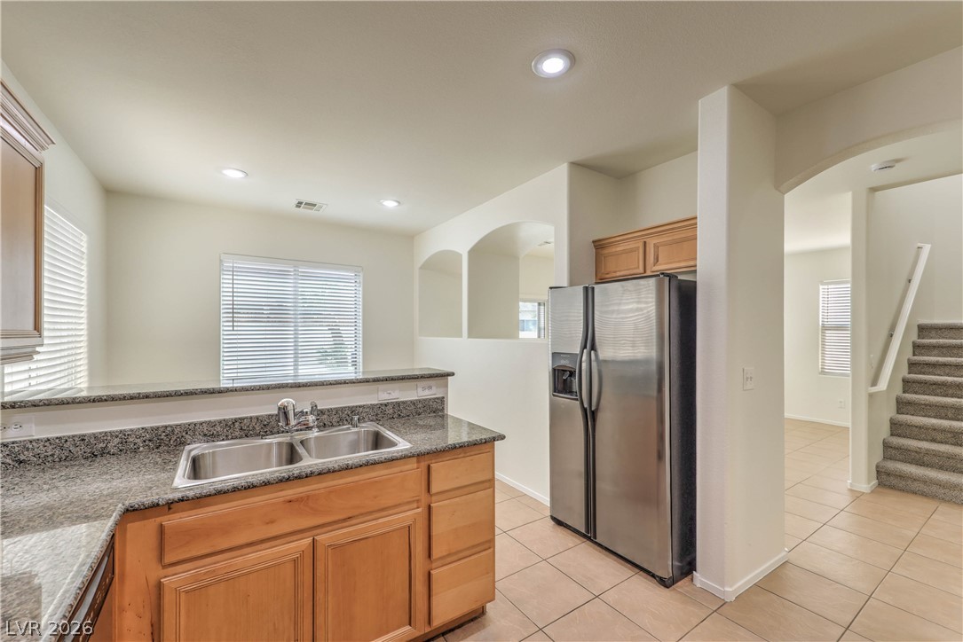 10939 Paradise Road Henderson, NV 89052 - Photo 9 of 36 A well-appointed kitchen boasts granite counters, dual sinks, and contemporary stainless steel appliances.