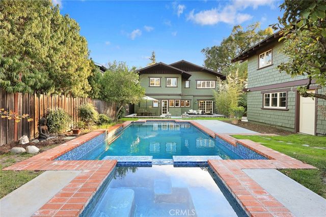 a view of a backyard with table and chairs under an umbrella
