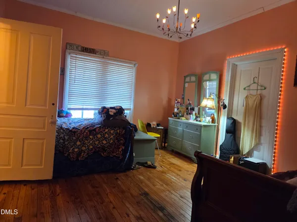 a bed room with furniture and a chandelier