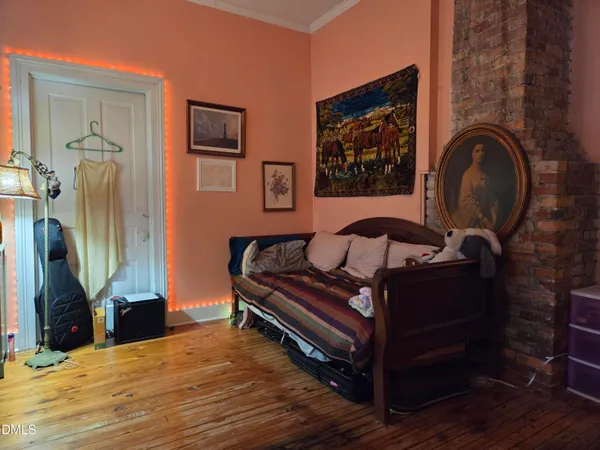 a bedroom with a bed and a mirror