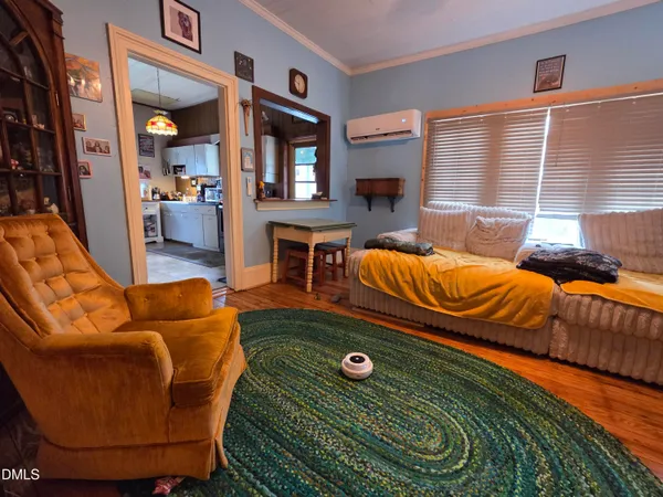 a living room with furniture a rug and a window