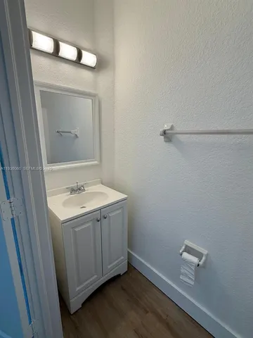 a view of a bathroom with a sink and mirror