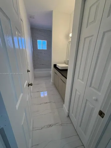 a bathroom with a sink and mirror