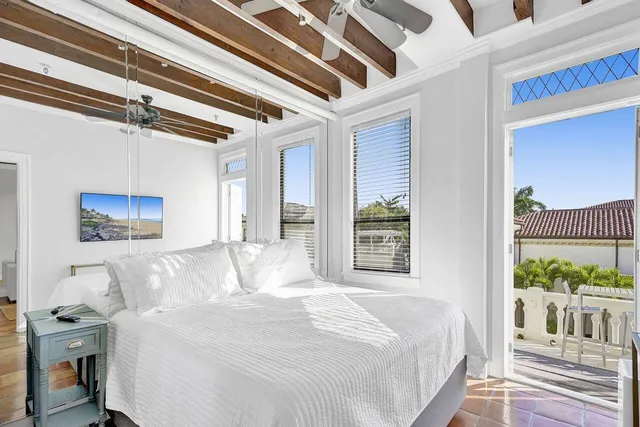 a bedroom with a bed and a painting on the wall