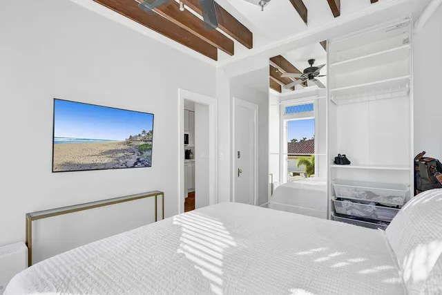 a bedroom with a bed and a painting on the wall