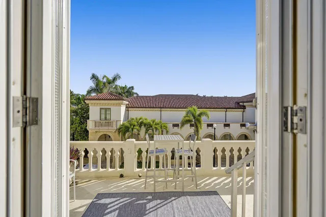a view of a house with a wooden bench